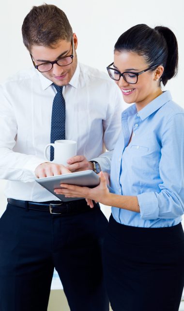 Portrait of business people working in the office with digital tablet.